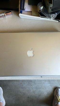 This Apple MacBook Pro features a classic aluminum finish with a prominent logo on the lid