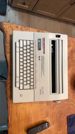 This Smith Corona 250 DLE typewriter features a white housing and includes specialized correction keys for easy typing errors.working like new electri