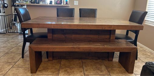 Large wood dining table with chairs and bench