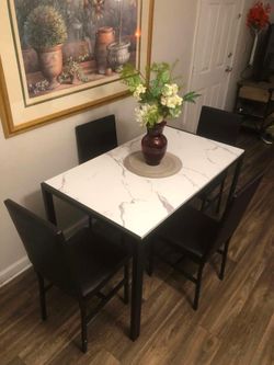 Like new white faux marble dining table set with 4 brown leather chairs