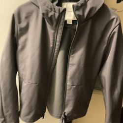 A Beautiful , Size Large, Calvin Klein, Grey Jacket, In Good Condition, But One Side Of The Bottom By The Zipper Has A Little Burn(NO SHIPPING)