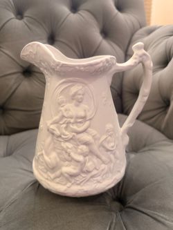 White Ceramic Pitcher with Embossed Figural Relief