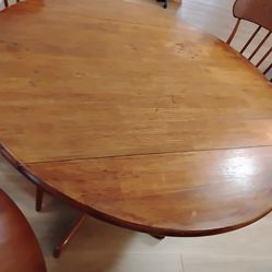 Solid wood table with 4 chairs. Table folds down for 2 people. Chairs are sturdy. Chairs are 100% wood also.  Clean,  no scratches or dents.