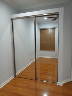 (2) Mirrored Sliding Closet Doors with Metal Frame