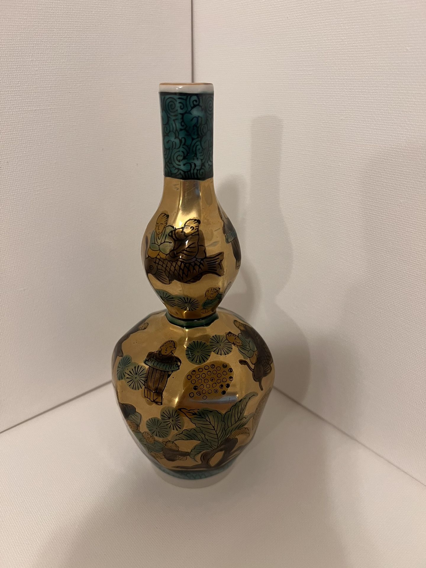 an antique Japanese vase hand-painted in gold