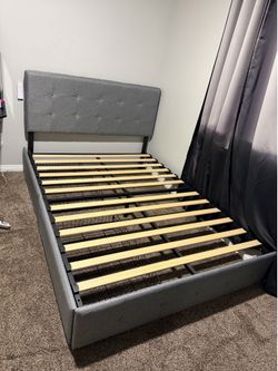Grey full size bed with sliding drawers