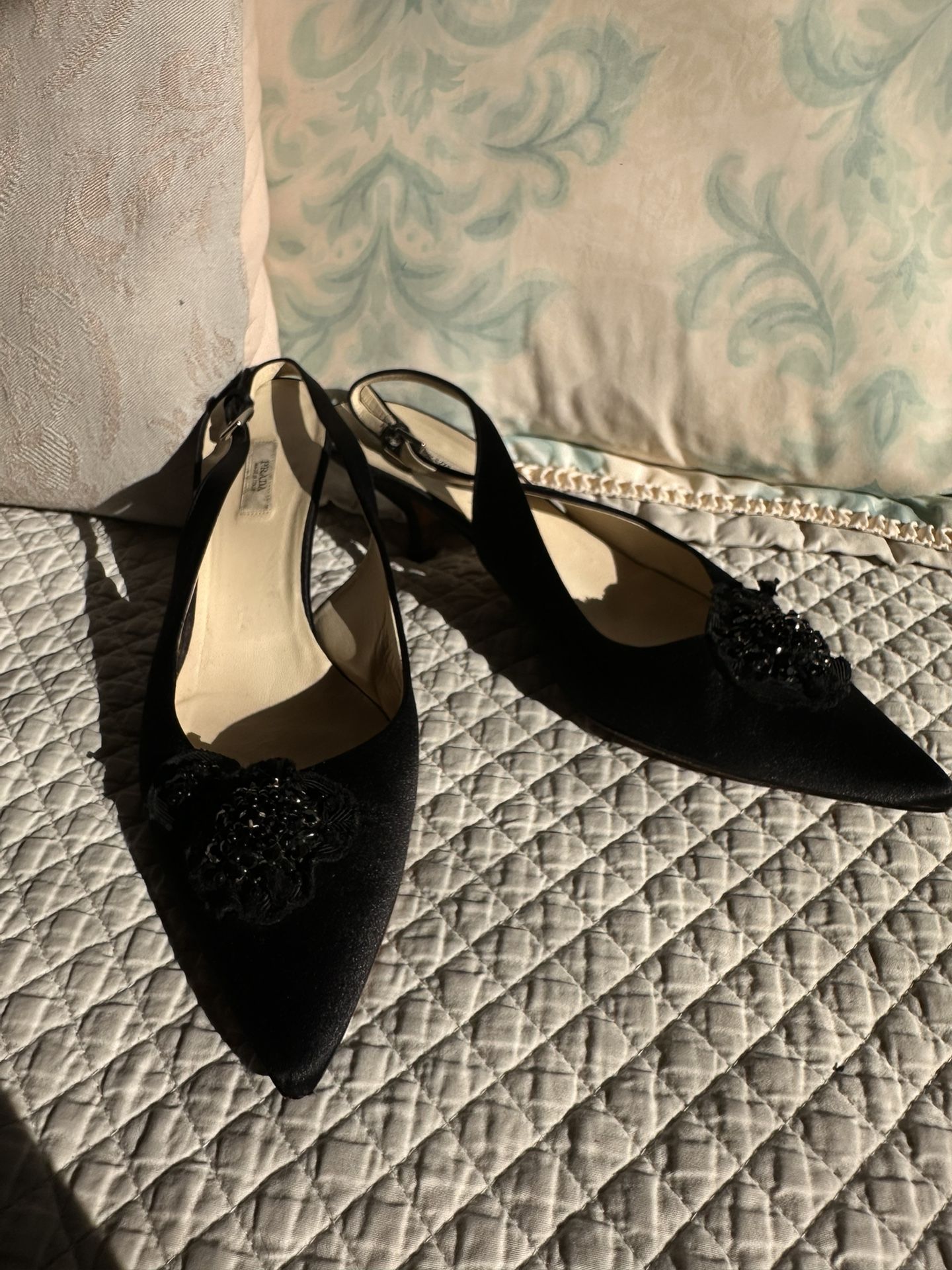 Prada black beaded slip-on heels.
