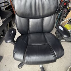 It's a chair that is a bit worn in some spots, but it's still in good condition—it just tilts slight