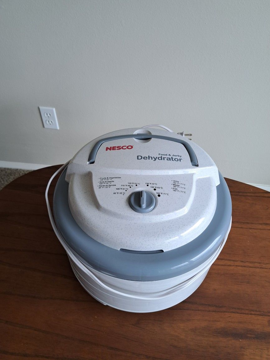 NESCO FD-75A Snackmaster Pro Food Dehydrator. For Snacks, Fruit, Beef Jerky. Gray. Includes 5 trays. Used - Like New.