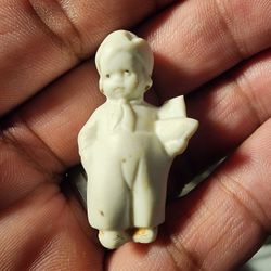 Tiny Ceramic Boy Holding Boat. Germany Stamp On Back