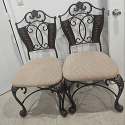 Set of four ornate metal dining chairs