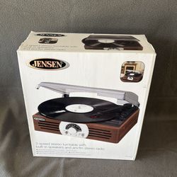Jensen JTA-222 3-Speed Stereo Turntable with built-in speakers and an AM/FM stereo radio. 