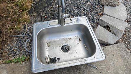 Stainless steel sink with faucet.