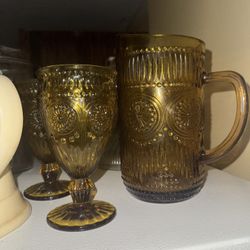  amber-colored glassware from The Pioneer Woman Adeline collection, including a pitcher and goblets.