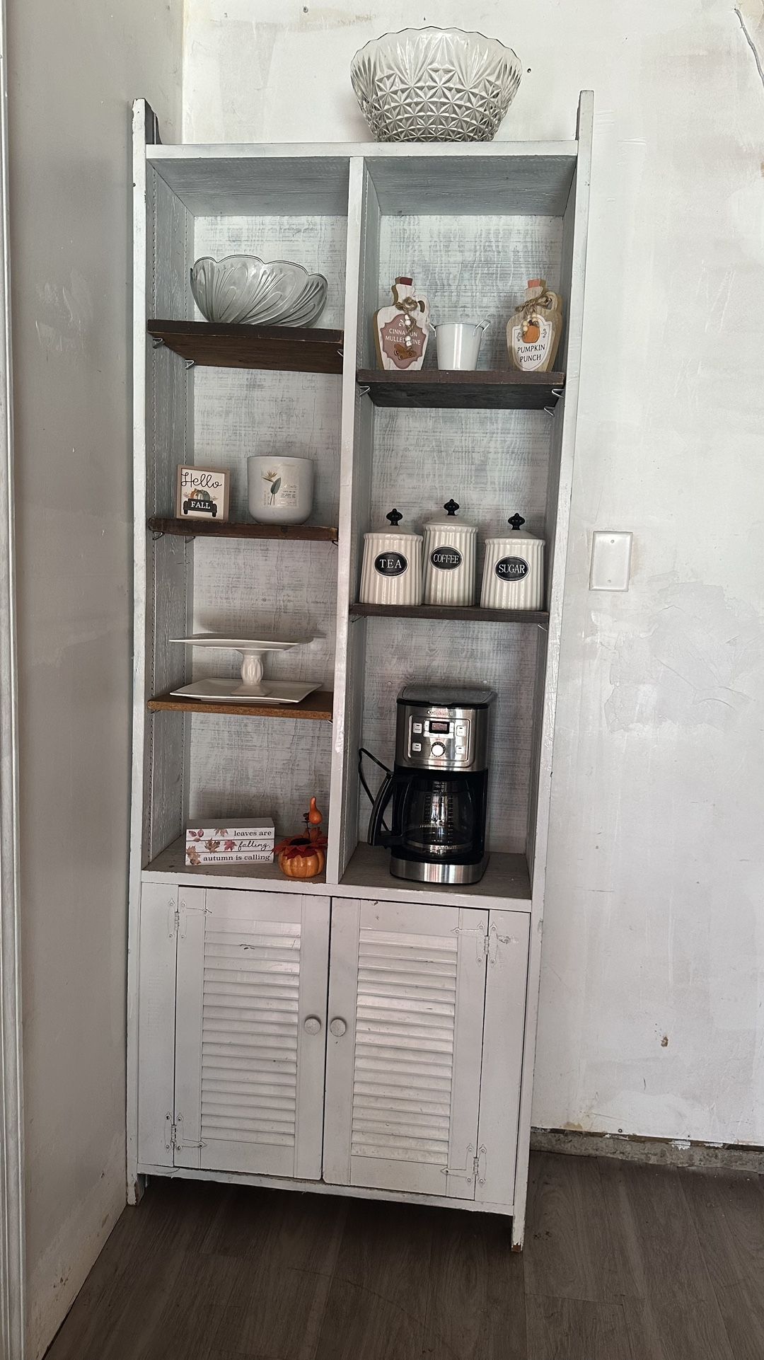 White shelving unit with decor & bottom drawers