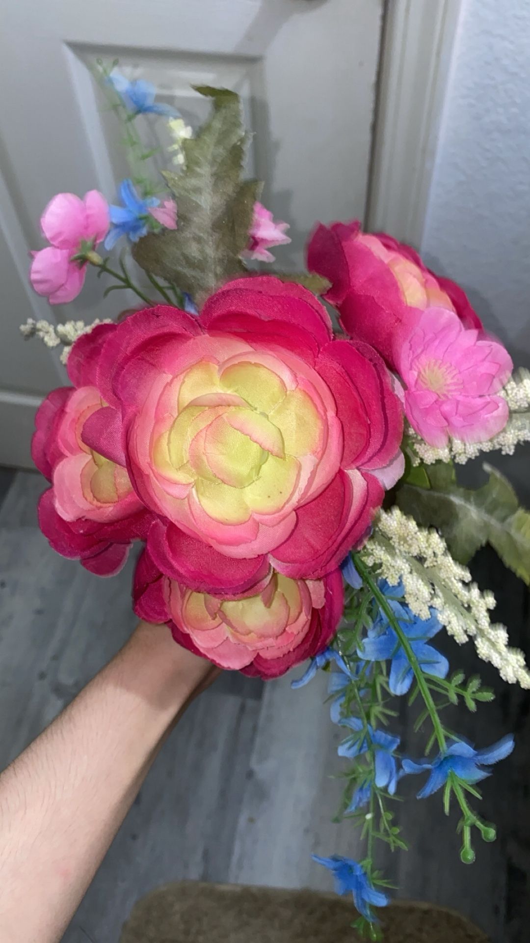 bouquet of artificial fuchsia pink ranunculus flowers.
