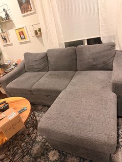 Pull out couch with reversible storage chaise