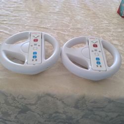 Two Nintendo Wheels Plus Controllers.