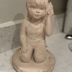 Dee Crowley & Austin Productions Sculpture 1985. Girl with a seashell sculpture titled "Listening". 