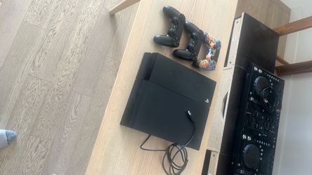 Sony PlayStation 4 Console with Two Controllers
