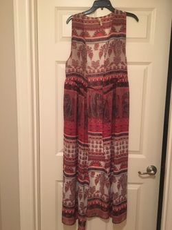 Like New Juniors size small long vest. Sheer material with red/white/black print. Smoke free home.