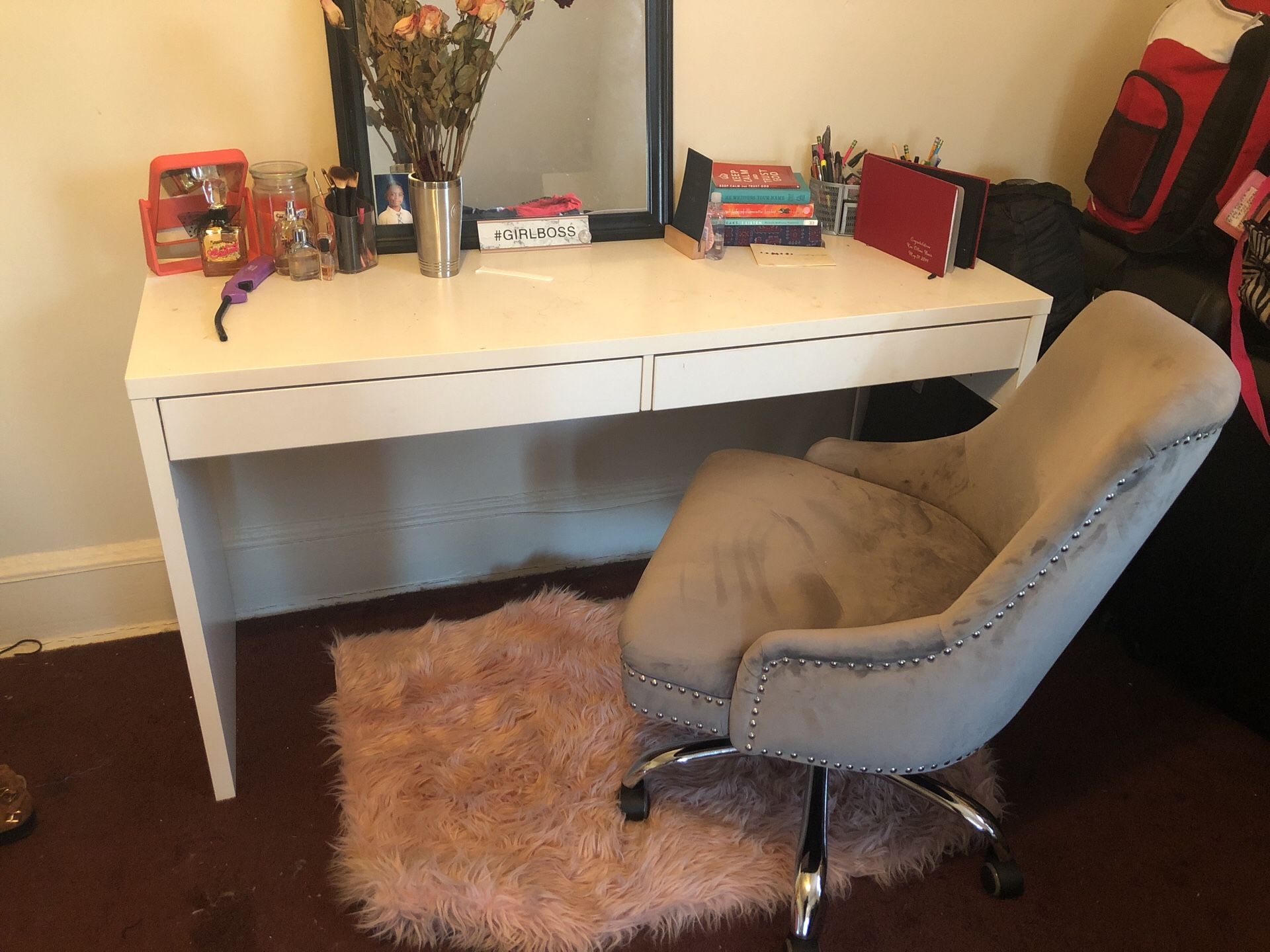 White desk and grey suede chair