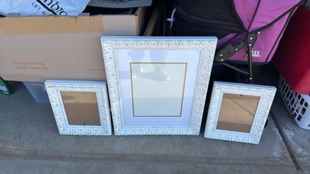 Beautiful white and gold picture frames a large 11 x 14 and then 28 by tens
