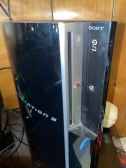 Sony PlayStation 3 Console with games and controllers and charging dock
