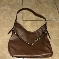 Brown Purse With Gold Chain Attached 