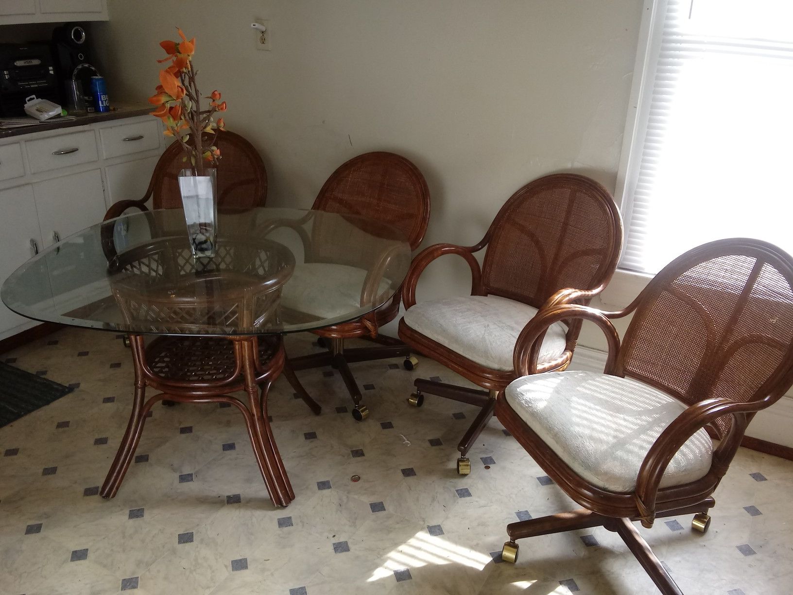 Glass kitchen table set very clean with the four chairs.