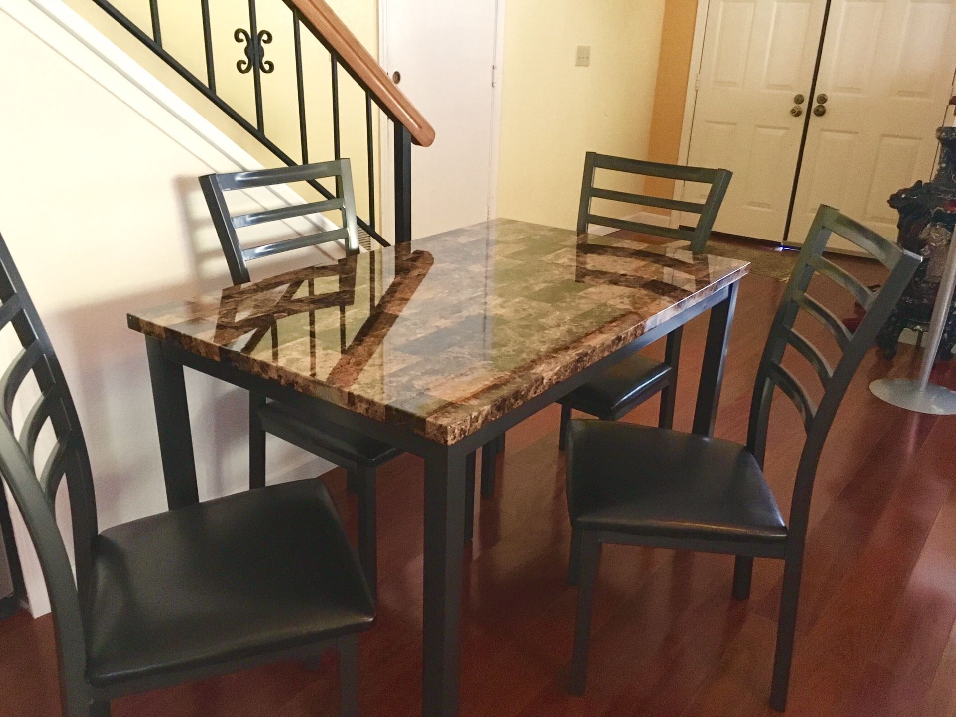 Brand new dining table with 4 chairs. Free curbside delivery included