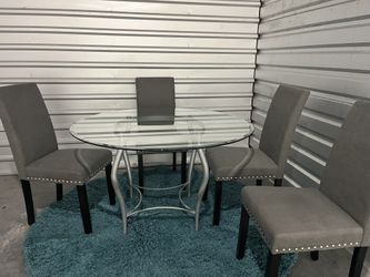 Glass top dining table 54 inches with four high back chairs