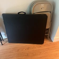 6ft Black Folding Table And 4 Beige Folding Chairs