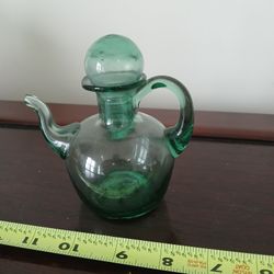 vintage hand-blown green glass cruet with a stopper