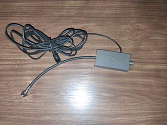 Official Nintendo NES RF Switch Adapter (Model NES-003), which is used to connect retro consoles like the NES, Super Nintendo (SNES), or Nintendo 64 t