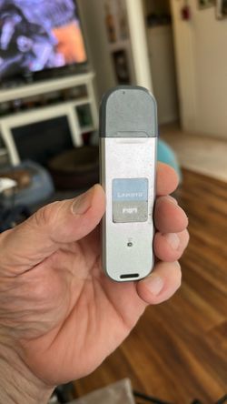 The image shows a Linksys WUSB54GC Compact Wireless-G USB Adapter.  Functionality: This adapter allows you to connect your desktop or notebook compute