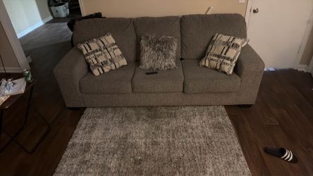 Couch for sale with rug and pillows