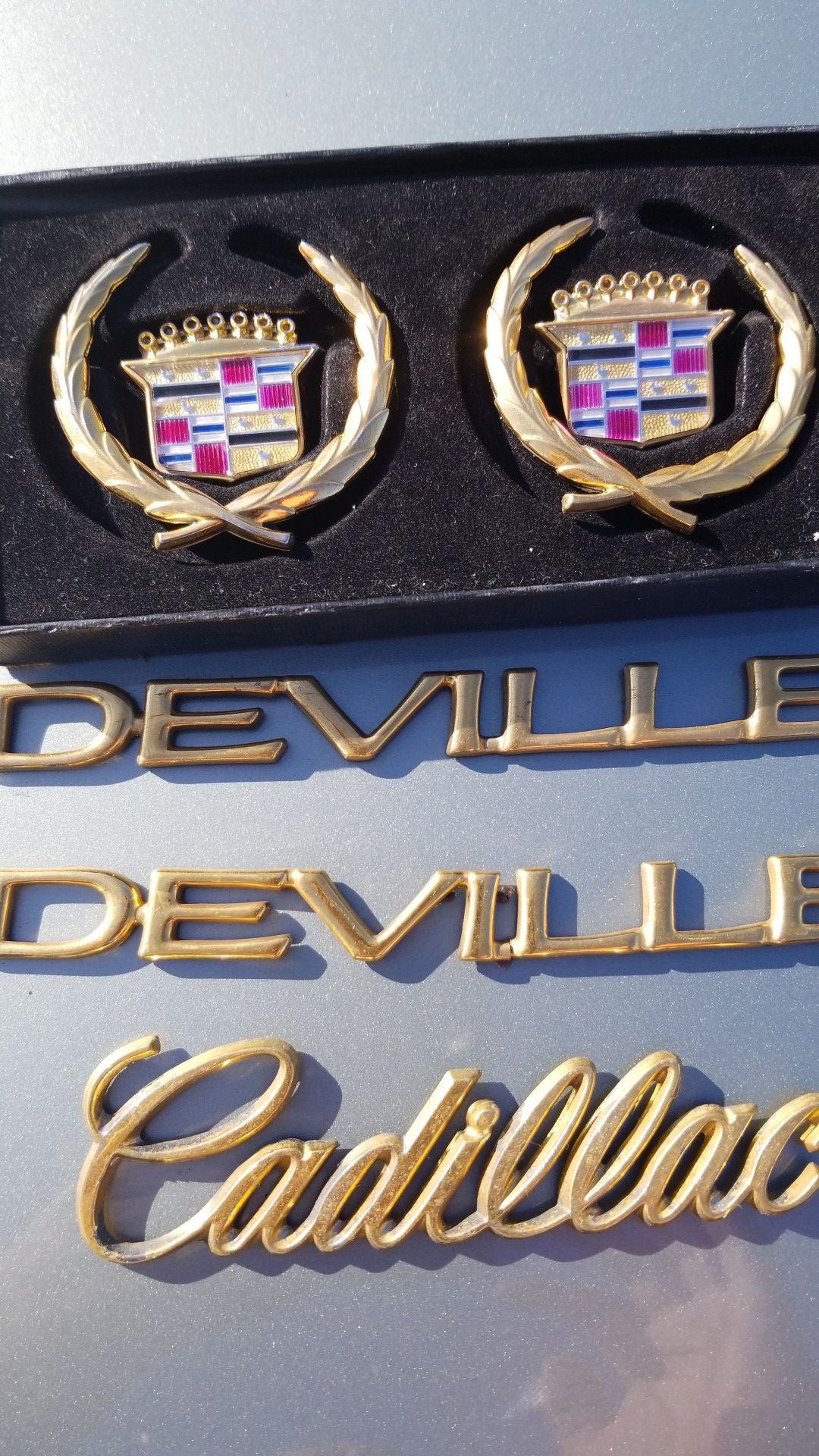 Gold Cadillac emblems
