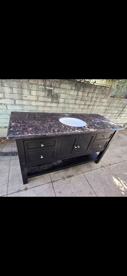 Vanity, marble (most likely) top. Good shape