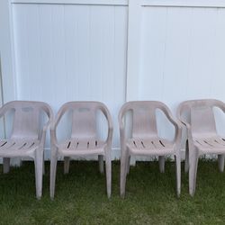 Four outdoor stackable chairs
