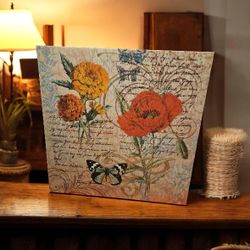 Decorative canvas with floral and butterfly design.