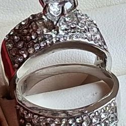 New  set of two women’s designer/fashion rings, size 10.
Princess-style silver tone with a beautiful, elegant look.
Both rings come in a lovely red gi