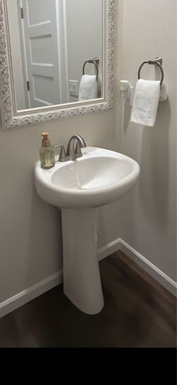 Pedestal sink and brushed nickel faucet