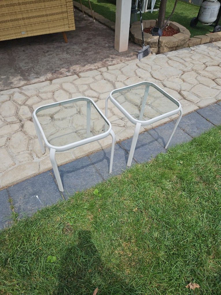 Two small glass top patio tables