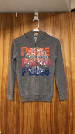 Kid’s size large (10-12) full hoodie with a glittery peace sign on the front