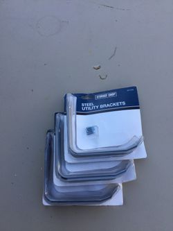 Three sets of metal shelf brackets