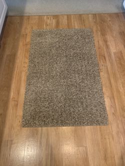 46“ x 29 1/2“ thick, multicolored tan, brown, and taupe rug by Mohawk homes