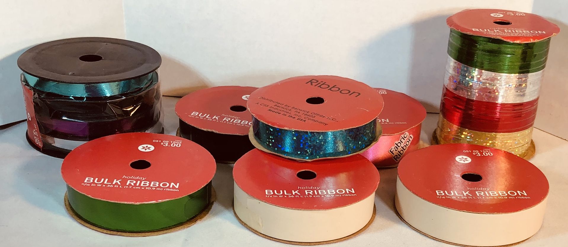 Eight (8) Rolls of Ribbon (Multiple Colors). 2 of the Rolls have 4 different ribbon colors each, plus 6 single color rolls. 340 TOTAL FEET!