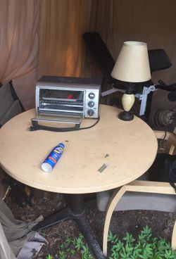 Tablewithmetalframewood top, 2 cushion wood chairs, stone lamp,or black and decker oven