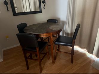 Round pub-height table + 4 chairs (wood/faux leather)
